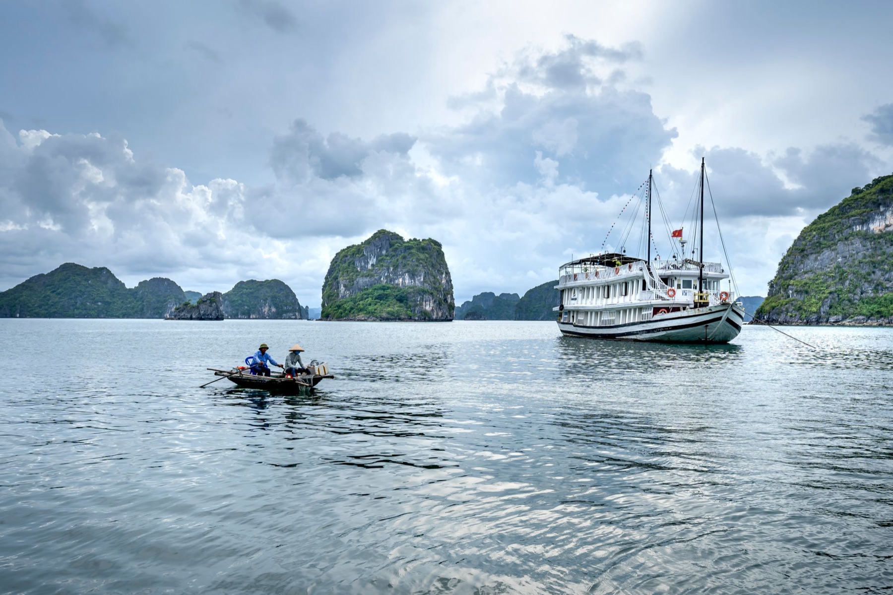 Ha Long Bay — A serene view of fishing boats near limestone islands in Ha Long Bay, Vietnam.
