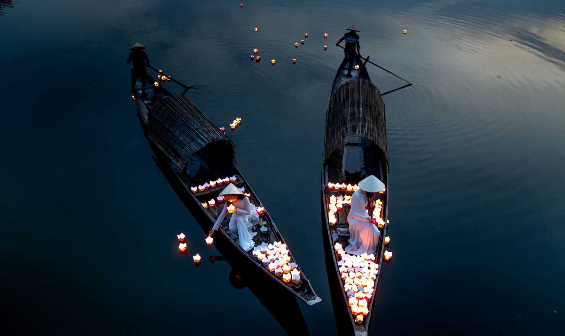 Hoi An — Peaceful scene of lantern-filled boats on a river at Hoi An Lantern Festival.