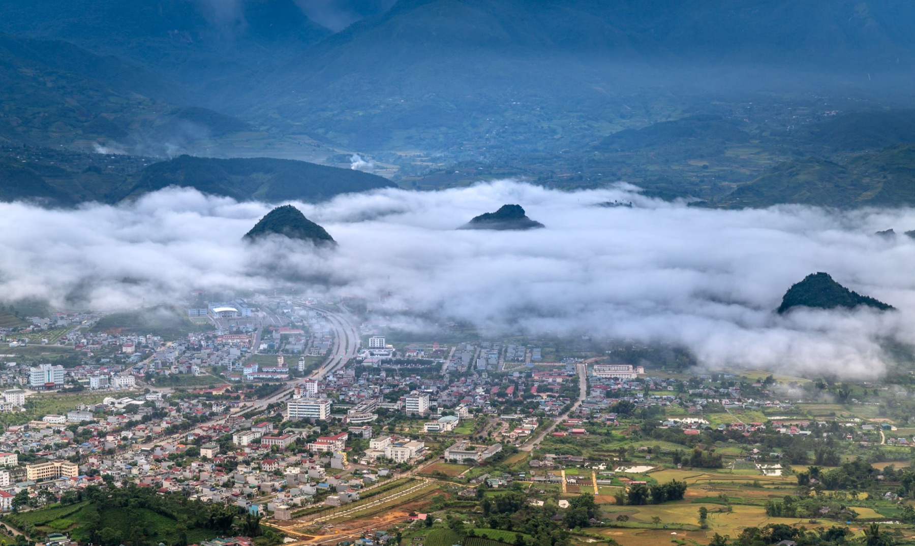 Mai Chau — Breathtaking aerial view of Lai Chau City framed by mist-covered mountains at da