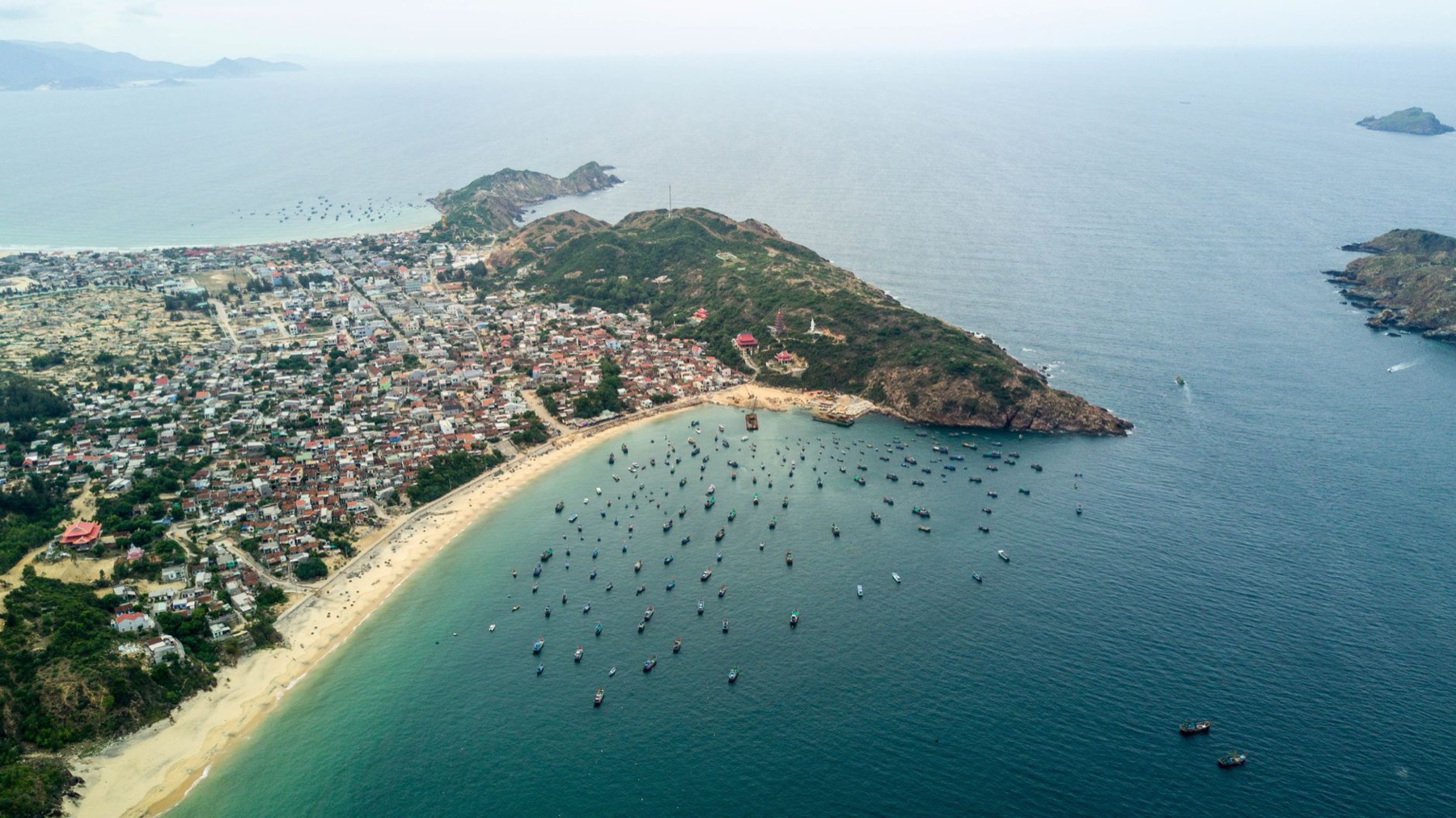 Quy Nhon — Explore the coastal beauty of Quy Nhon city with its busy harbor and lush green 